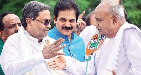 Former Chief Minister Siddaramaiah, state Congress in-charge  K C Venugopal and JDS supremo H D Deve Gowda at a protest against the BJP indulging in horsetrading, in Bengaluru, on Wednesday. (Photo | Pandarinath B, EPS)