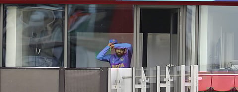 a's Rohit Sharma watches from the pavilion