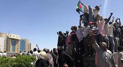 Sudanese demonstrators chant slogans outside the army headquarters. (Photo | AFP)