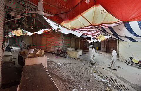 People walk through a main market which is closed due to a strike in Rawalpindi, Pakistan. (Photo | AP)