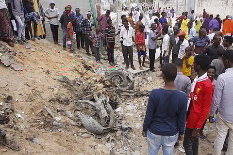 Somali people gather near destroyed buildings after a car bomb detonated in Mogadishu, Somalia, Monday July 8, 2019. (Photo | AP)