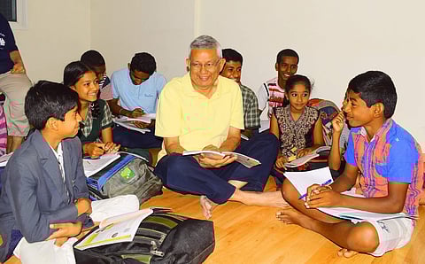 C S Narayanan conducts classes for slum children who stay near Puttenahalli Lake in Bengaluru. (Photo | Pandarinath B, EPS)