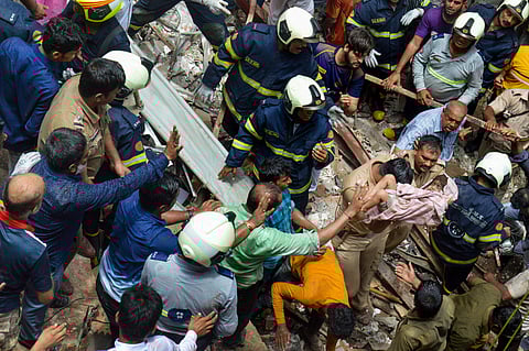 Fire Brigade and NDRF personnel carry out rescue works after the collapse of building in Mumbai. (Photo| PTI)