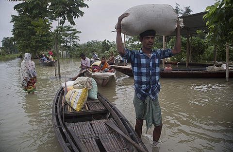 A flood affected villager carries food grains in Mizoram (Photo | AP)