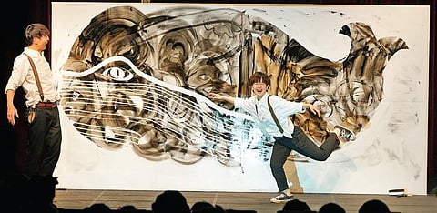 The production makes use of a whiteboard and projection system