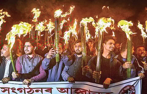 Activists of All Assam Students Union and other organisations at a torch light rally in Guwahati (File photo| PTI)