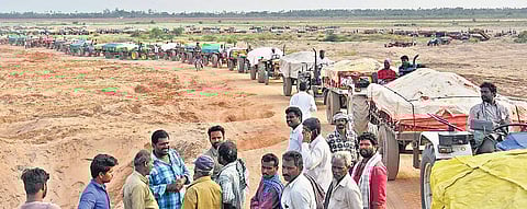 Tractors make a beeline after loading sand at Thotalvalluru reach near Vijayawada on Wednesday | P Ravindra Babu