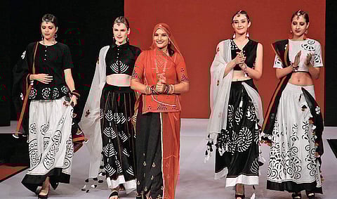 Winner of The Textiles Fairs India Fashion Design Awards 2019, Ruma Devi (in red) with models showcasing her collection