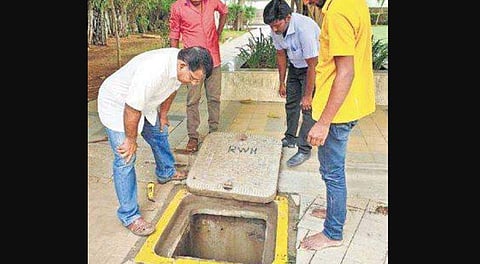 Residents checking the rain water harvesting system in an apartment complex in Kazhipattur | Express