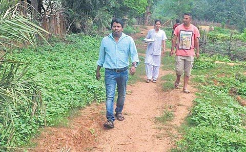 Dr Abhisek Nayak along with support staff walking to Betabani village (Photo | EPS)