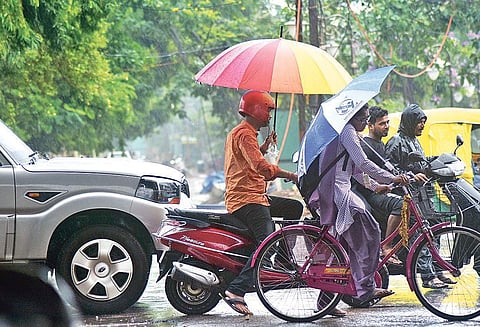 Commuters take cover from rains in Bhubaneswar.| ( File Photo | EPS )