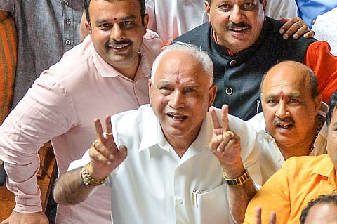 BS Yeddyurappa with his party MLAs show victory sign after HD Kumaraswamy lost the vote of confidence during Assembly Session at Vidhana Soudha in Bengaluru (File Photo | PTI)