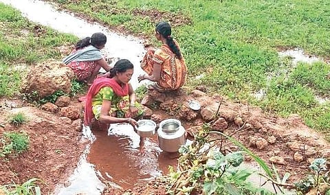 Women of Bandhaguda village under Mudulipada panchayat fetching water from a stream | ( Photo | EPS )