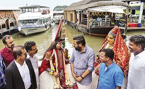 Tourism Minister Kadakampally Surendran interacting with kathakali artists on reaching Marine Drive to inaugurate the cruise boat terminal on Thursday. Actor Dharmajan Bolgatty is also seen | Albin Mathew