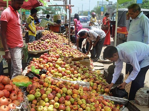 People buying apples from roadside vendors (File Photo | EPS)