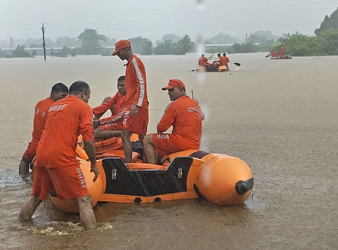 Rescue operations are underway after an estimated 1,500 passengers got stranded in the Mahalaxmi Express on the flooded railway tracks at Vangani, Maharashtra, on 27 July 2019. (Photo | PTI)