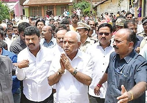 Chief Minister B S Yediyurappa greeting the gathering at his native village Bookanakere in Mandya district on Saturday