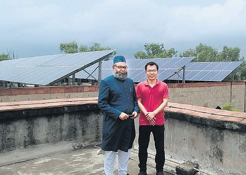 Prof. Ahteshamul Haque of Jamia Millia (left) and Prof Huai Wang of Alborg University, Denmark, on the roof of the engineering college at Jamia | Express