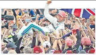 Hamilton crowdsurfing after his victory in Britain