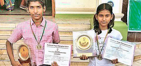 A Janarthanan  and S Abarna Sree with the gold medal and citation they won at Yoga Olympiad | Express