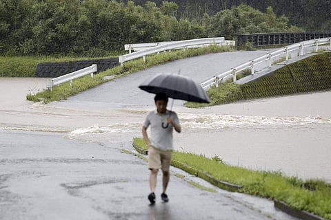A flooded road is seen during heavy rain in Soo City, Kagoshima Prefecture, southwest Japan. (Photo | AP)