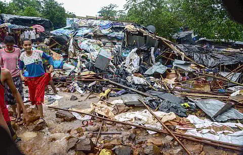 Debris seen after a portion of a compound wall collapsed on shanties adjacent to it due to heavy rainfall at Malad, East Mumbai (Photo | PTI)
