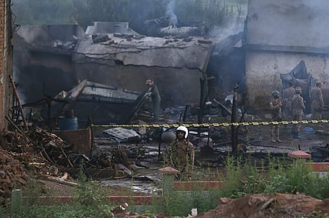 Pakistan army officials examine the site of a plane crash in Rawalpindi. (Photo|AP)