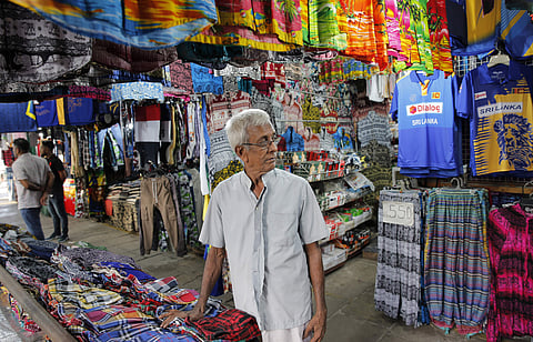 76-year-old Ranepura Hewage Jayasena waits for customers at shop selling mementos in Colombo (Photo | AP)