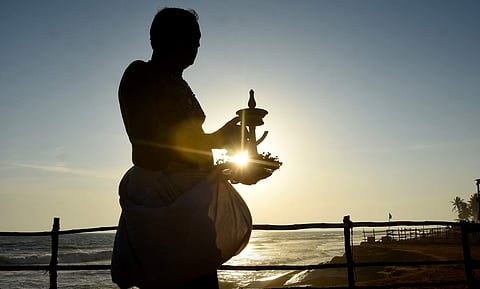 A priest makes preparations for Wednesday's Karkidaka Vavu Bali ceremony at Shankumugham beach in Thiruvananthapuram. (Photo | B P Deepu, EPS)