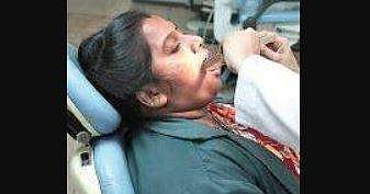 A dentist examines a pourakarmika at the programme launched by Biocon Foundation 