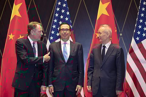 U.S. Trade Representative Robert Lighthizer, left, gestures towards Treasury Secretary Steven Mnuchin as he chats with Chinese Vice Premier Liu He, right, before they pose for a photo at the Xijiao Conference Center in Shanghai on Wednesday, July 31, 2019
