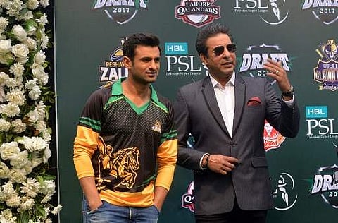 Cricket player Shoaib Malik speaks and former Pakistani cricket captain Wasim Akram. (File Photo | AFP)
