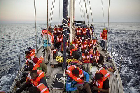Migrants rest on a Mediterranea Saving Humans NGO boat, as they sail off Italy's southernmost island of Lampedusa 