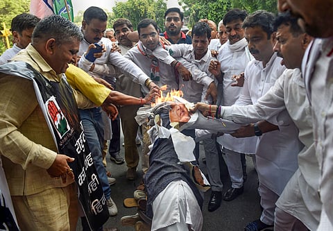 Congress supporters burn an effigy of BJP leader Subramanian Swamy during a protest against his remarks over Rahul Gandhi outside his residence in New Delhi on 7 July 2019. (Photo | PTI)