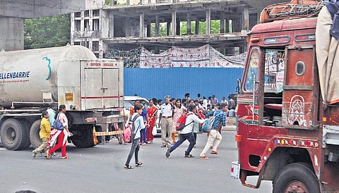 Pedestrians risk their lives as they cross a road during heavy traffic  hours in Vijayawada on Saturday | Prasant Madugula