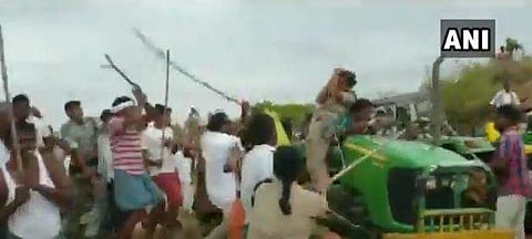 TRS men allegedly beating up forest range officer Anitha (on tractor) in Sirpur, Telangana (File Photo | ANI)