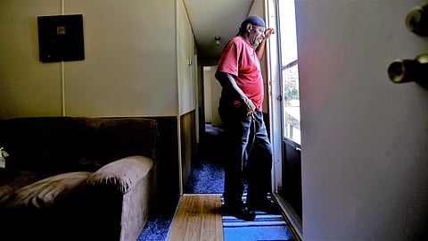 In this photo taken Wednesday, May 29, 2019, resident James Lesane stands at the entrance to his mobile home in Lumberton, N.C. Every month, Lesane pays what he can afford for his mobile home lot rental; $150. (Photo | AP)