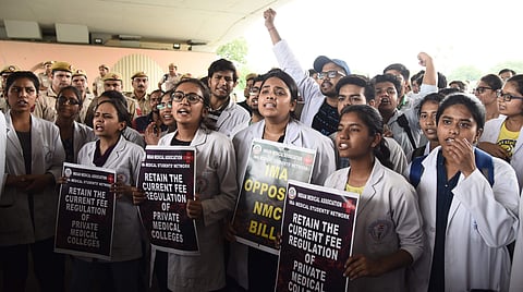Doctors and medical students of AIIMS display placards during a strike to protest the introduction of the National Medical Commission NMC Bill in the Rajya Sabha in New Delhi. (Photo | Parveen Negi, EPS)