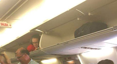Southwest Airlines attendant resting inside an overhead bin. (Photo | @Disko_InVERNo, Twitter)