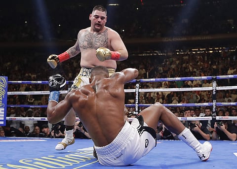 Andy Ruiz knocks down Anthony Joshua during the third round of a heavyweight title boxing match in New York. (Photo | AP)