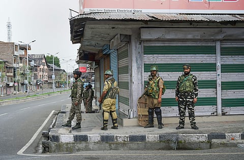 Security personnel stand guard during curfew like restriction on fifth consecutive day in Srinagar Friday August 9 2019. | PTI