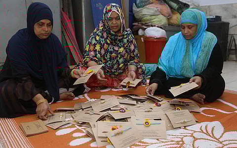 Muslim women make Rakhi in New Delhi on Saturday ( Express Photo by Arun Kumar)