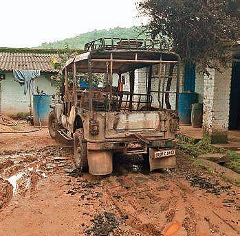 A burnt vehicle in front of the liquor factory in Pottangi (Photo |EPS)