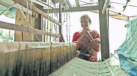 Indira, a weaver, is aghast at the sight of the damaged loom on her return to her house at Karimpadam on Sunday. The weavers have just rescovered from the impact of last year’s deluge. (Photo | Arun Angela)