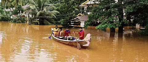 Members of Kasma Football Club at Kuriyad rescue people stranded on the first floor of a house on Sunday. (Photo | Albin Mathew)