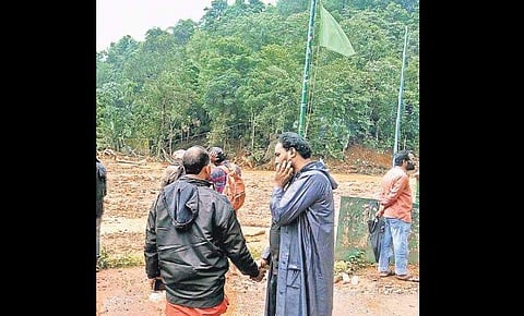 Aksar Kannankadan (R) at the search site at Puthumala in Wayanad.