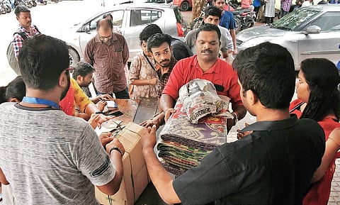 Relief materials for flood victims being packed at a collection centre in Government Women’s College, Thiruvananthapuram. (Photo | B P Deepu)