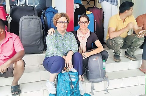 Lulu and Pamela from Paris await their turn in front of the Air India Express booking office near Durbar Hall. (Photo | A Sanesh)