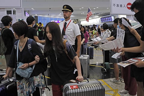 Passengers and flight crew arrive at Hong Kong International Airport, Monday, Aug. 12, 2019. One of the world's busiest airports canceled all flights after thousands of Hong Kong pro-democracy protesters crowded into the main terminal Monday afternoon. (P