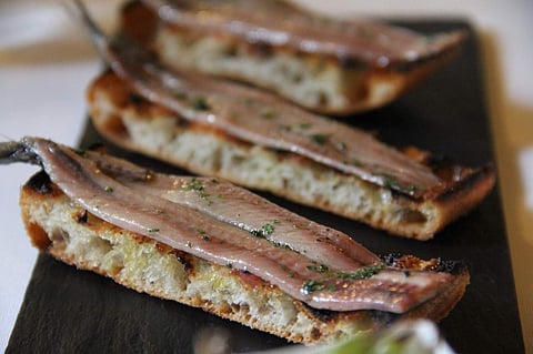 Grilled anchovy fillets over flatbread. (File Photo | Reuters)